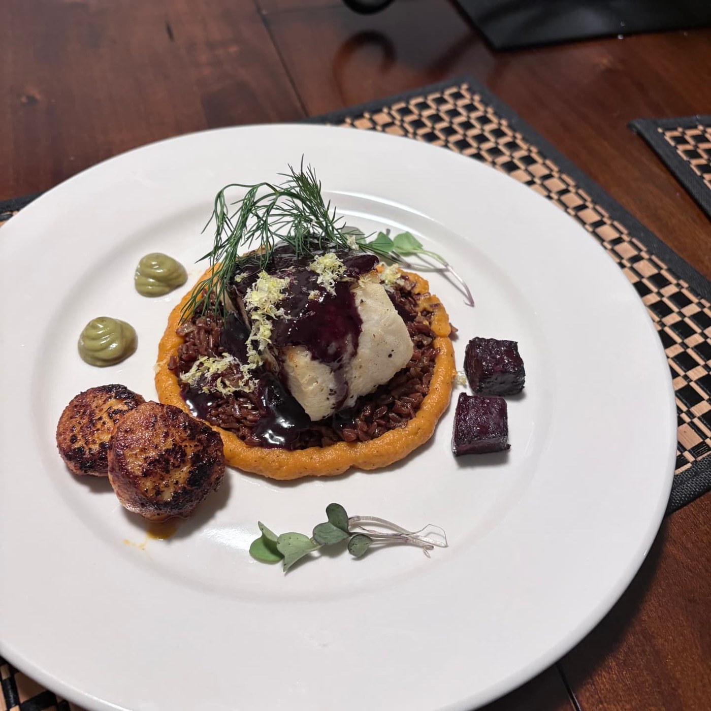Seared fish on red rice with sweet potato purée and scallops